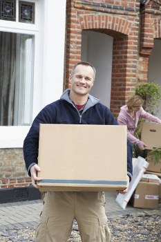 Professional piano removals team preparing an upright piano in Knightsbridge