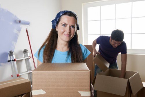 Movers securing furniture with blankets and straps for safe transport