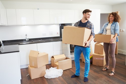 Residential movers in Knightsbridge transporting boxes and furniture carefully