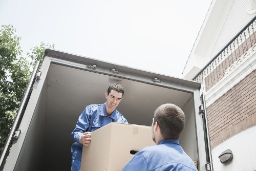 Removal team loading boxes and household items in central London